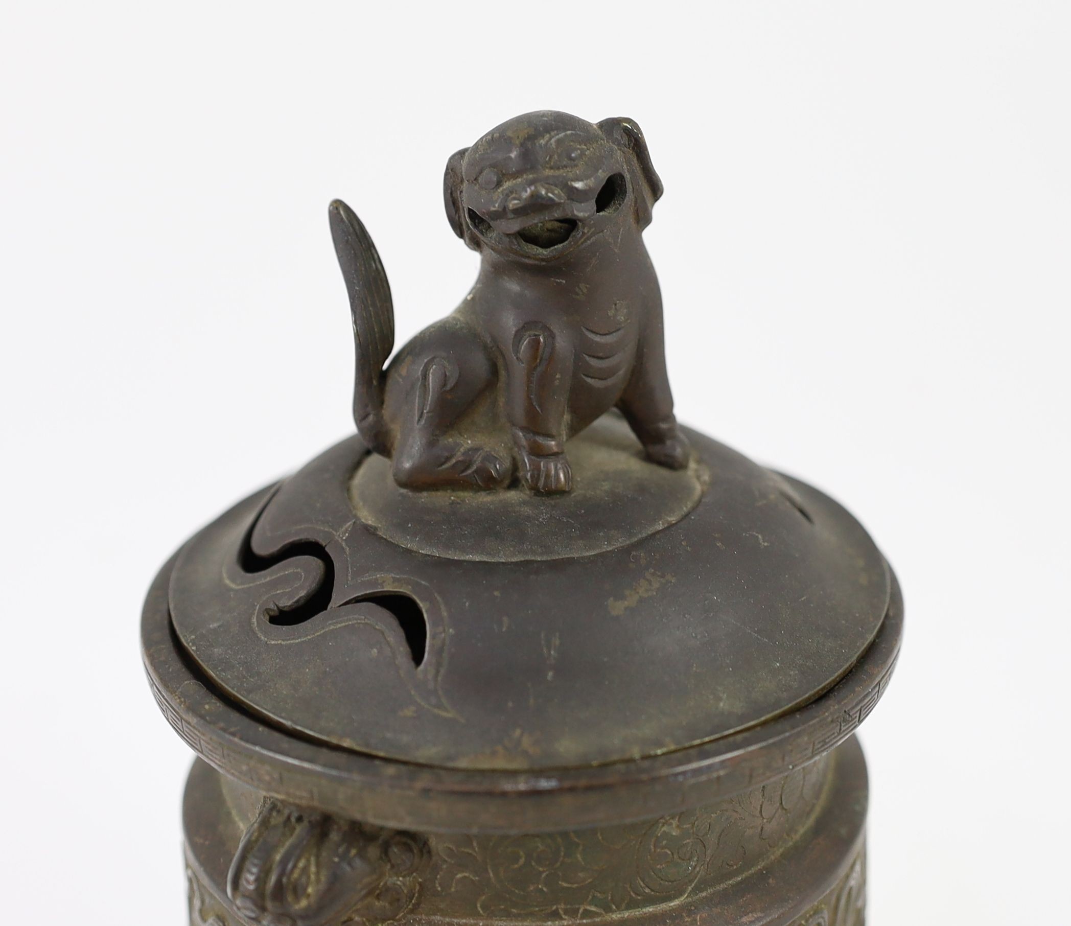 A Chinese bronze tripod censer, ding, Xuande mark, 18th/19th century, with associated cover and stand, 9.5 cm diameter